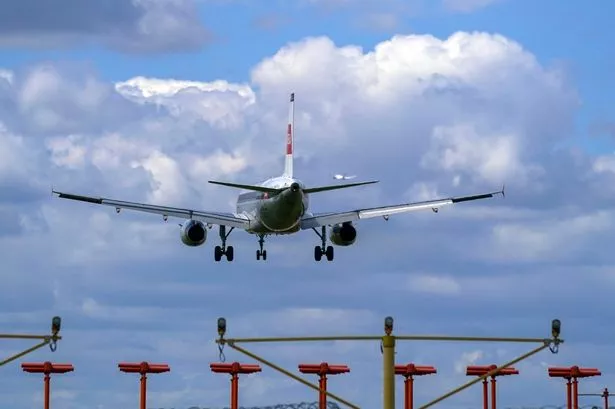 A plane lands on the southern runway at Heathrow Airport