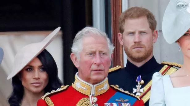 Meghan, Duchess of Sussex, Prince Charles, Prince of Wales and Prince Harry, Duke of Sussex stand on the balcony of Buckingham Palace during Trooping The Colour 2018 on June 9, 2018 in London, England