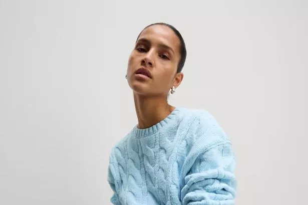 A model wearing the blue Chenille Cable Knit Crew Neck Relaxed Jumper