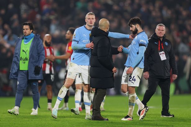 Erling Haaland and Josko Gvardiol of Manchester City and Pep Guardiola interact at full-time following the team's draw in the Premier League match at Brentford