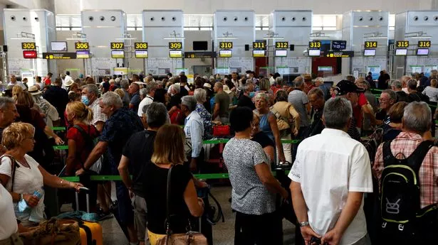 Passengers queue at check-in desks at Malaga-Costa del Sol Airport