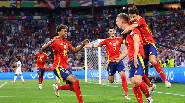 MUNICH, GERMANY - JULY 09: Dani Olmo of Spain celebrates with teammates Lamine Yamal and Jesus Navas after Jules Kounde of France (not pictured) concedes an own goal, resulting in the second goal for Spain, during the UEFA EURO 2024 Semi-Final match between Spain and France at Munich Football Arena on July 09, 2024 in Munich, Germany. (Photo by Boris Streubel - UEFA/UEFA via Getty Images)