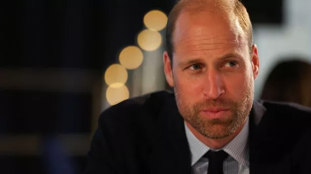 Close-up of Prince William with a beard and looking serious