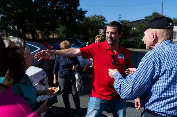 Republican Congressional candidate Derrick Anderson speaks to supporters on the first day of early voting in Virginia at the Orange County Registrar's Office in Orange, Va., on Friday, September 20, 2024. 