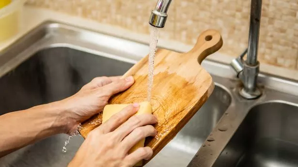 Cleaning wood cutting board in kitchen sink