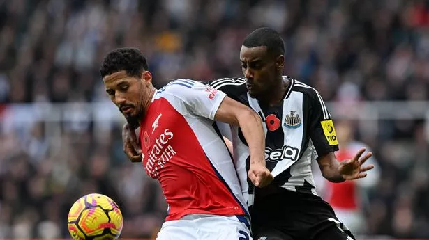 William Saliba of Arsenal FC (2) shields the ball from Alexander Isak of Newcastle United (14) during the Premier League match between Newcastle United FC and Arsenal