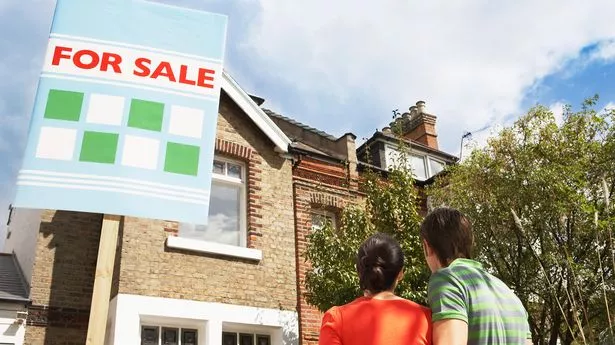 Couple in front of house