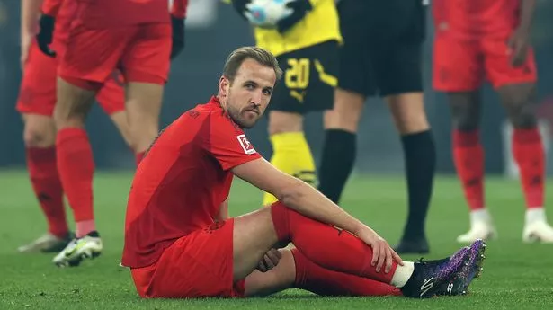 DORTMUND, GERMANY - NOVEMBER 30: Harry Kane of Bayern Munich goes down with an injury during the Bundesliga match between Borussia Dortmund and FC Bayern München at Signal Iduna Park on November 30, 2024 in Dortmund, Germany. (Photo by Lars Baron/Getty Images)