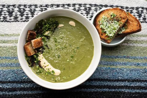 Vegetarian broccoli soup with fresh toppings, and a side of toasted bread with herb butter.