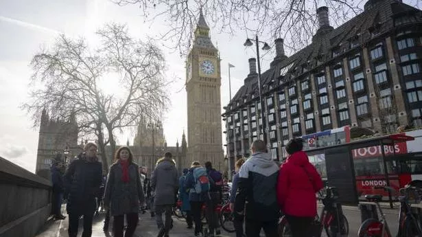 Citizens and tourists enjoy their time in the city centre as Big Ben is seen behind while daily life continues in London, United Kingdom (stock photo)