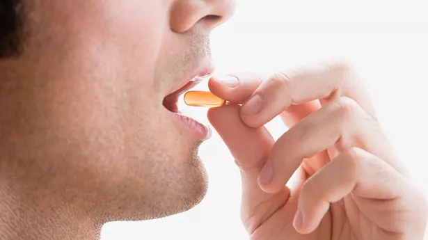 Man taking vitamin pill