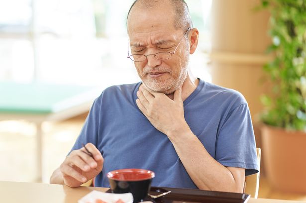 Man struggling to eat meal