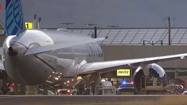 A united airline plane sits on a runway