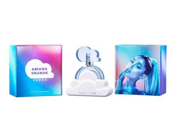 Ariana Grande cloud perfume with white and blue bottle in shape of cloud seen next to bright blue and pink packaging which shows Ariana's face