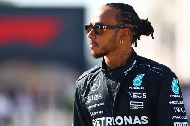 BAHRAIN, BAHRAIN - FEBRUARY 21: Lewis Hamilton of Great Britain and Mercedes walks in the Paddock during day one of F1 Testing at Bahrain International Circuit on February 21, 2024 in Bahrain, Bahrain.