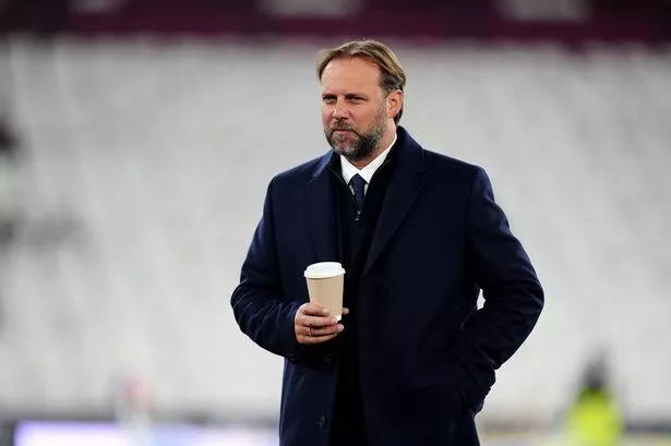 Tim Steidten holding a coffee cup