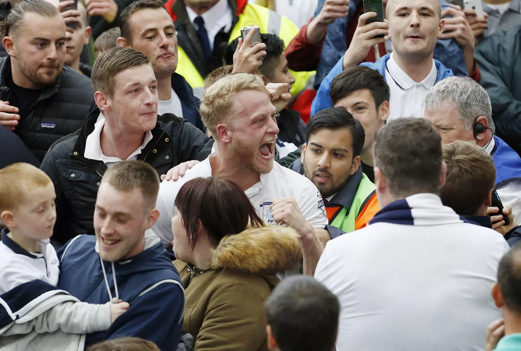 Preston North End's Tom Clarke celebrates after the match with fans on the pitch