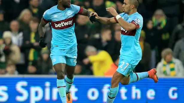 Dimitri Payet of West Ham United celebrates scoring his team's first goal with his team mate Victor Moses