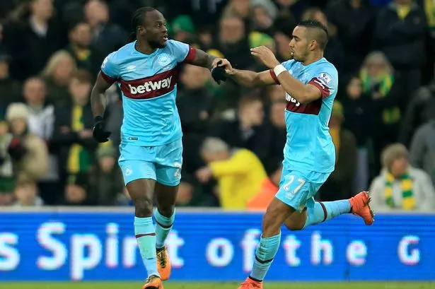 Dimitri Payet of West Ham United celebrates scoring his team's first goal with his team mate Victor Moses 