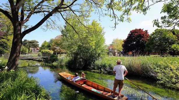 Tourists enjoys punting through Westgate Gardens in Canterbury, Kent,