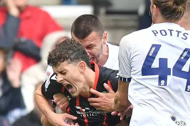 Blackburn Rovers' Owen Beck seems to be bitten on the neck by Preston North End's Milutin Osmajic