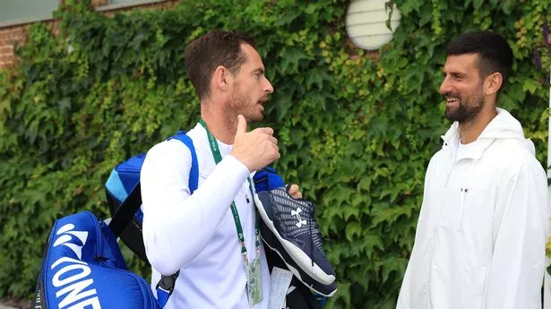 Novak Djokovic of Serbia (R) speaks with Andy Murray