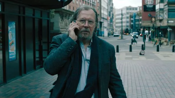 Gary Oldman is dressed in a filthy suit and on the phone in scenes from Slow Horses where he stars as MI5 boss Jackson Lamb