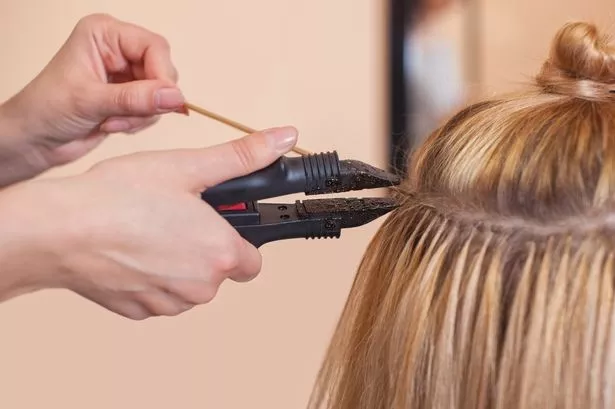 Woman getting hair extensions