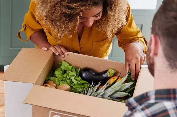 A couple looking at their Oddbox delivery