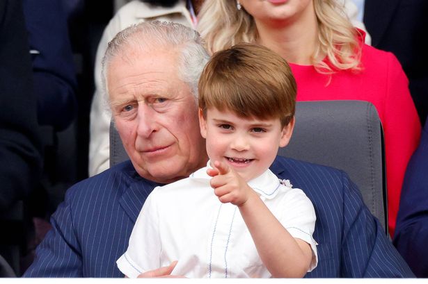 Prince Louis of Cambridge sits on his grandfather Prince Charles, Prince of Wales's lap