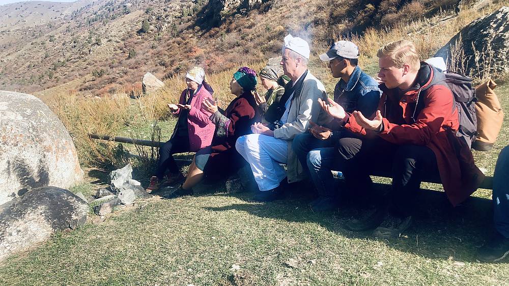 Ritual of candle-lighting in a sacred site, Kyrgyzstan