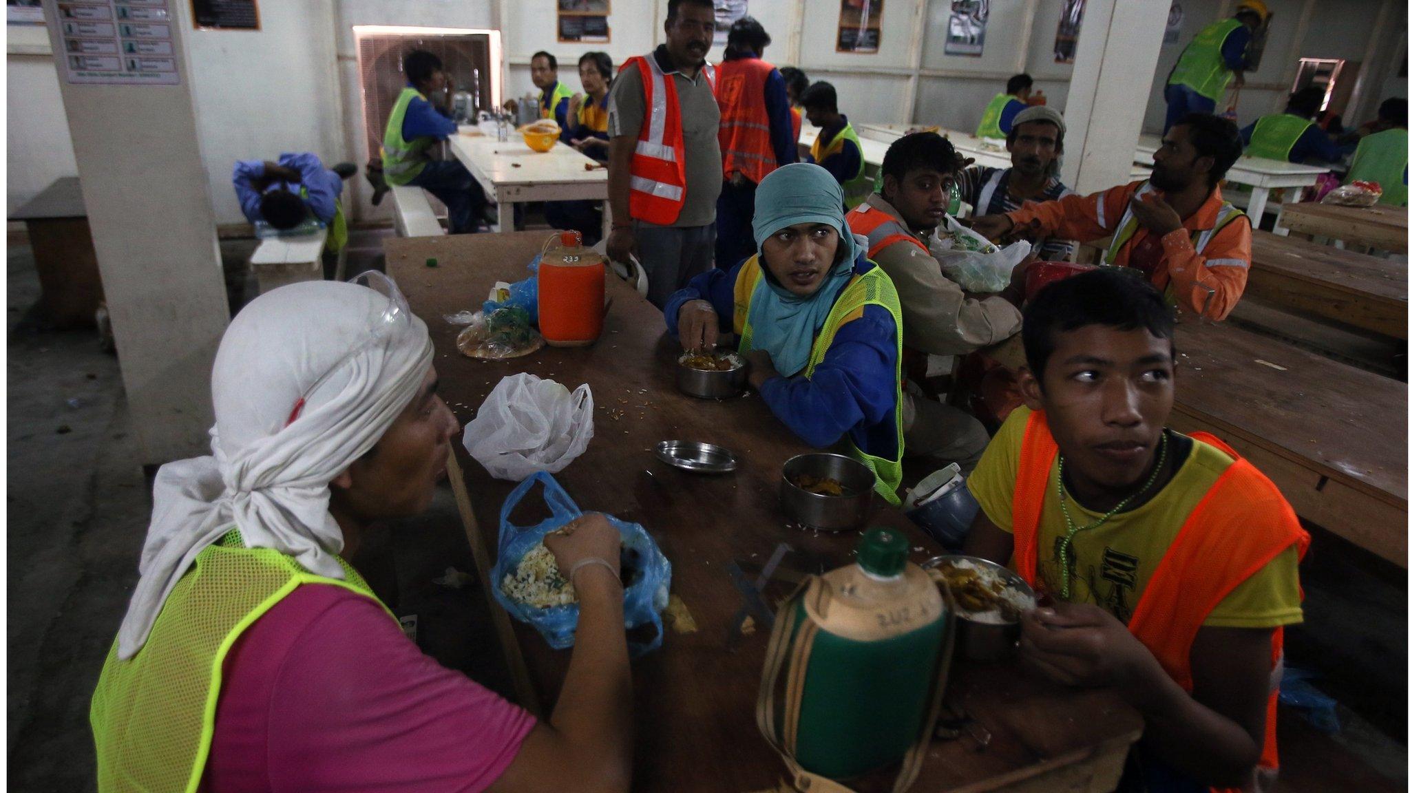 Migrant labourers have a lunch break as they work on a construction site on October 3, 2013 in Doha in Qatar