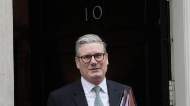 Sir Keir Starmer stands outside 10 Downing Street on his way to Prime Minister's Questions, holding a couple of red folders