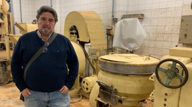 Businessman Pascual Andreu stands in his factory, which was damaged by flood water