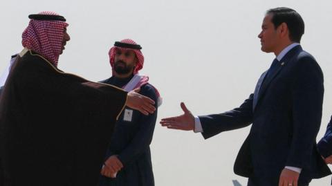 US Secretary of State Marco Rubio (right) shakes hands with Saudi Arabia's Deputy Minister for Protocol Affairs Abdulmajeed Al-Smari at King Khalid International Airport, in Riyadh (17/02/25)