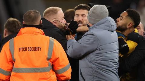 Matheus Cunha fights with a member of Ipswich's security team