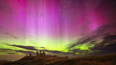 A purple and yellow sky over a castle.