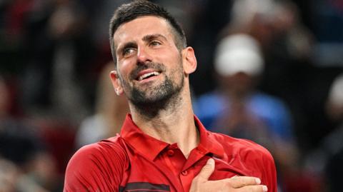 Novak Djokovic celebrates victory at the China Open in October 2024