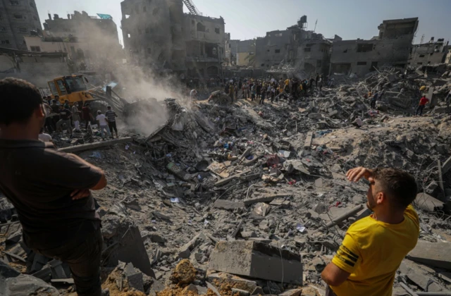 Palestinians search for bodies and survivors among the rubble following Israeli airstrikes on Al Falouja in Jabalia town, northern Gaza