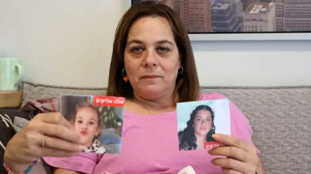 Maayan Zin, the mother of Dafna (15) and Ela (8), believed to have been taken hostage by Palestinian Hamas militants during the October 7 attack, shows pictures of her daughters