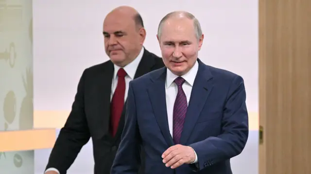 Russian President Vladimir Putin (R) and Russian Prime Minister Mikhail Mishustin (L)