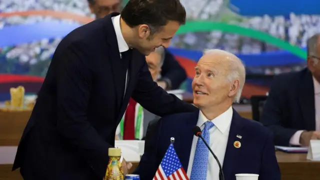 France's President Emmanuel Macron and U.S. President Joe Biden speak during the G20 summit at the Museum of Modern Art in Rio de Janeiro