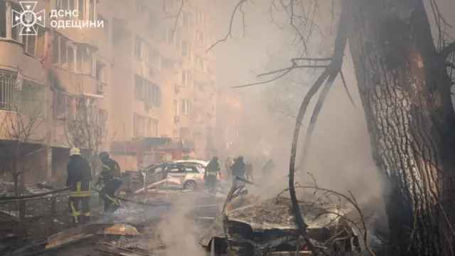 Firefighters work at the site where a residential area was hit by a Russian missile strike, amid Russia's attack on Ukraine, in Odesa