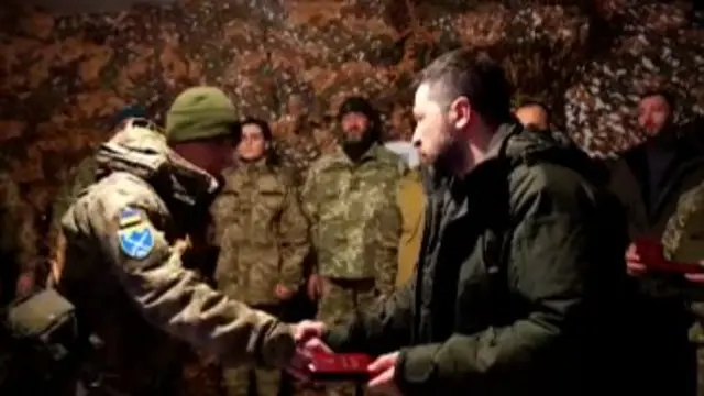 Zelensky shakes the hand of a soldier