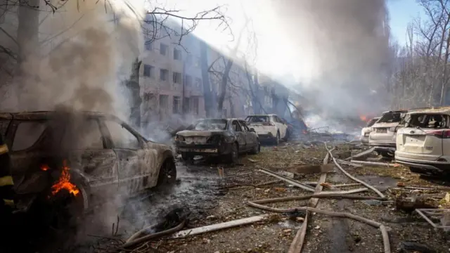 smouldering cars are seen on a roadway lined with debris in Odesa