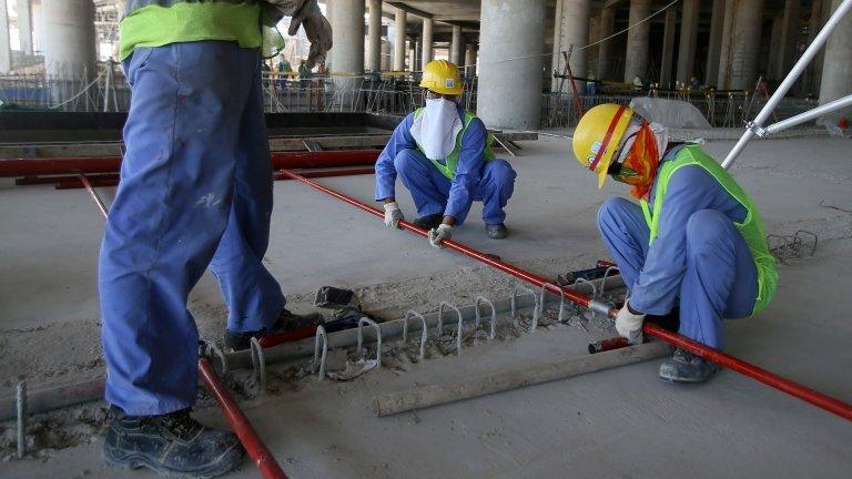 Migrant labourers work on a construction site in Doha in Qatar