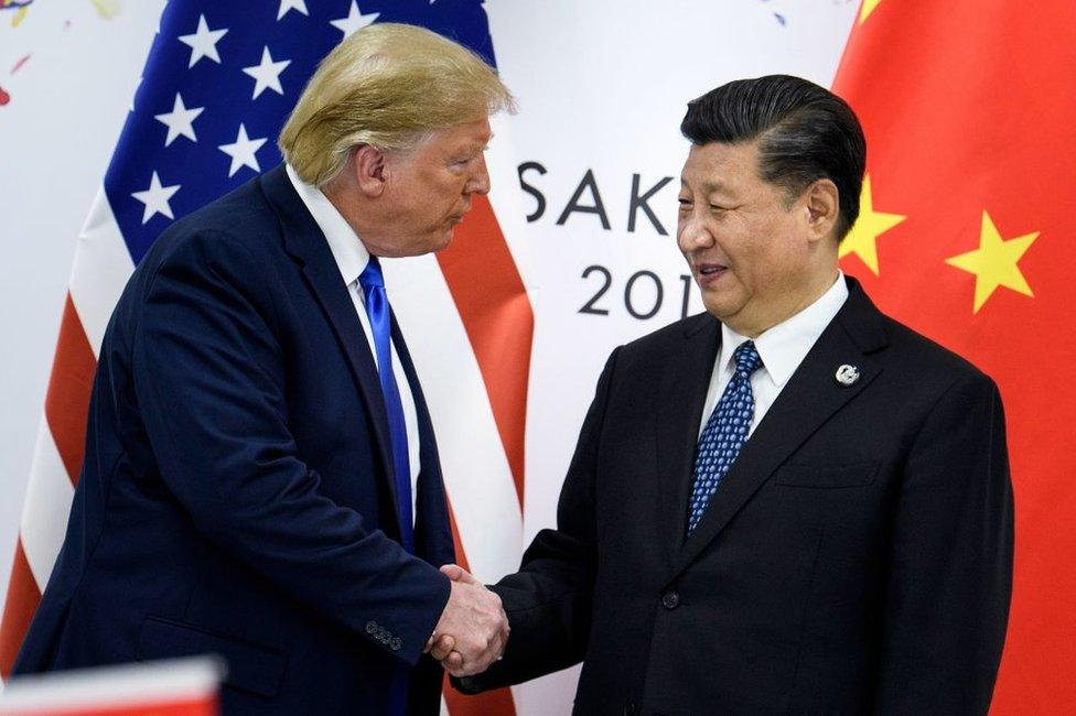 Former US President Donald Trump (L) shakes hands with Chinese President Xi Jinping (R) on 28 June, 2019 at the G20 Summit in Osaka