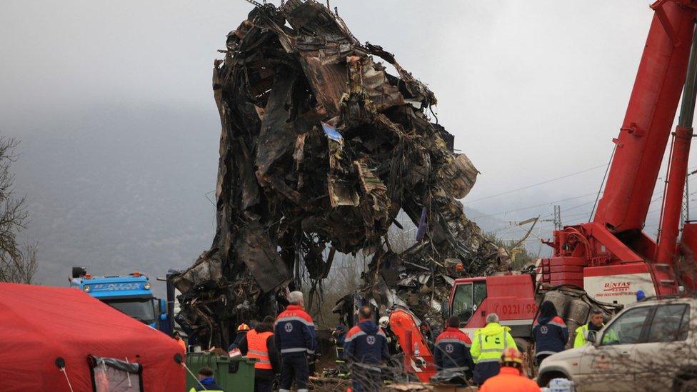 Remains of a destroyed train carriage being removed by crane on Thursday morning