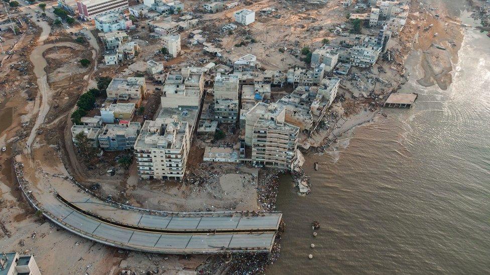 Drone shot shows destruction in Derna including a large road which has been swept away