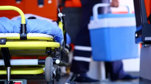 Getty Images A paramedic transporting an organ donation